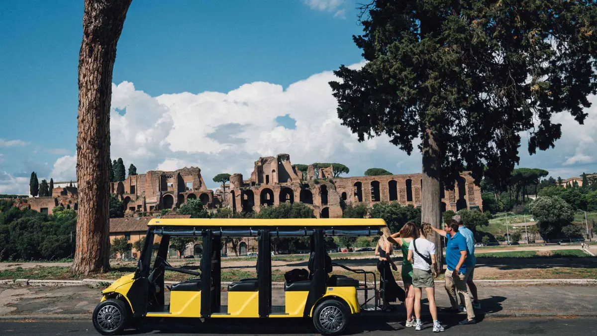 Golf cart on the basalt paving of the Via Appia Antica during a Rome underground tour with catacomb entry